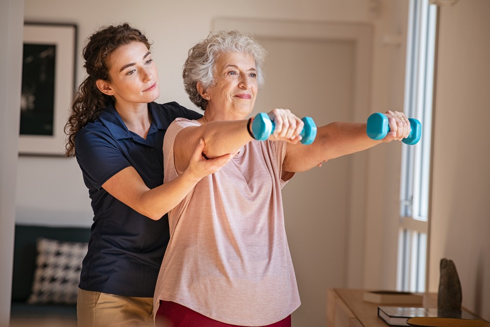 Senior woman doing physical rehabilitation with therapist