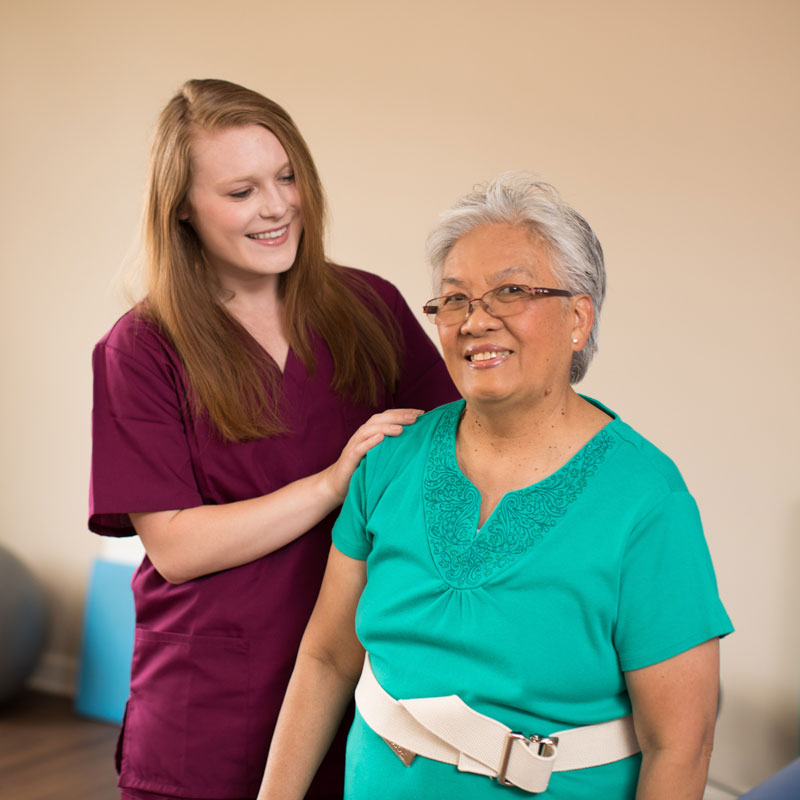 senior woman with caregiver in rehabilitation