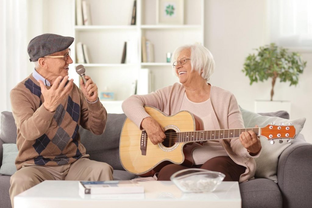 Senior couple playing guitar 