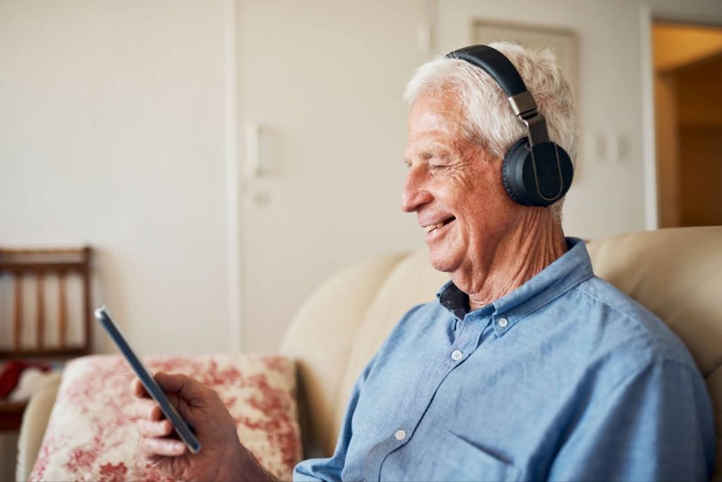 Senior man listening to an audio book