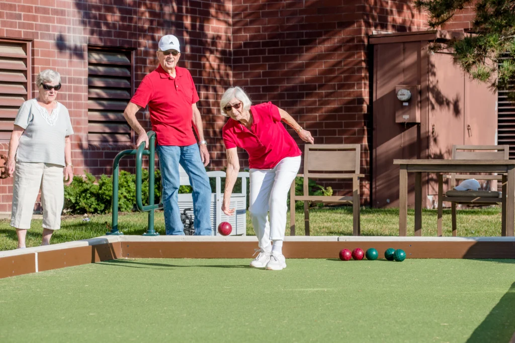 3 seniors playing bocce ball at Wyndemere in Wheaton, IL to better their cholesterol and aging.