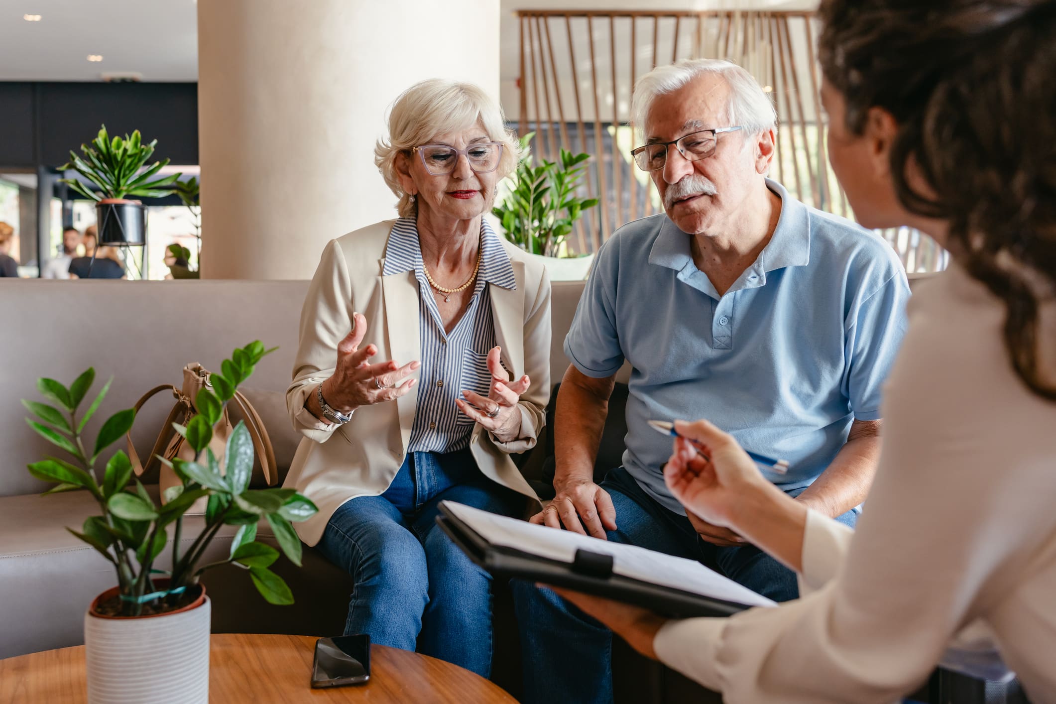 Senior couple meeting with a financial advisor to ask "Can I Afford a CCRC?" at Wyndemere in Wheaton, IL.
