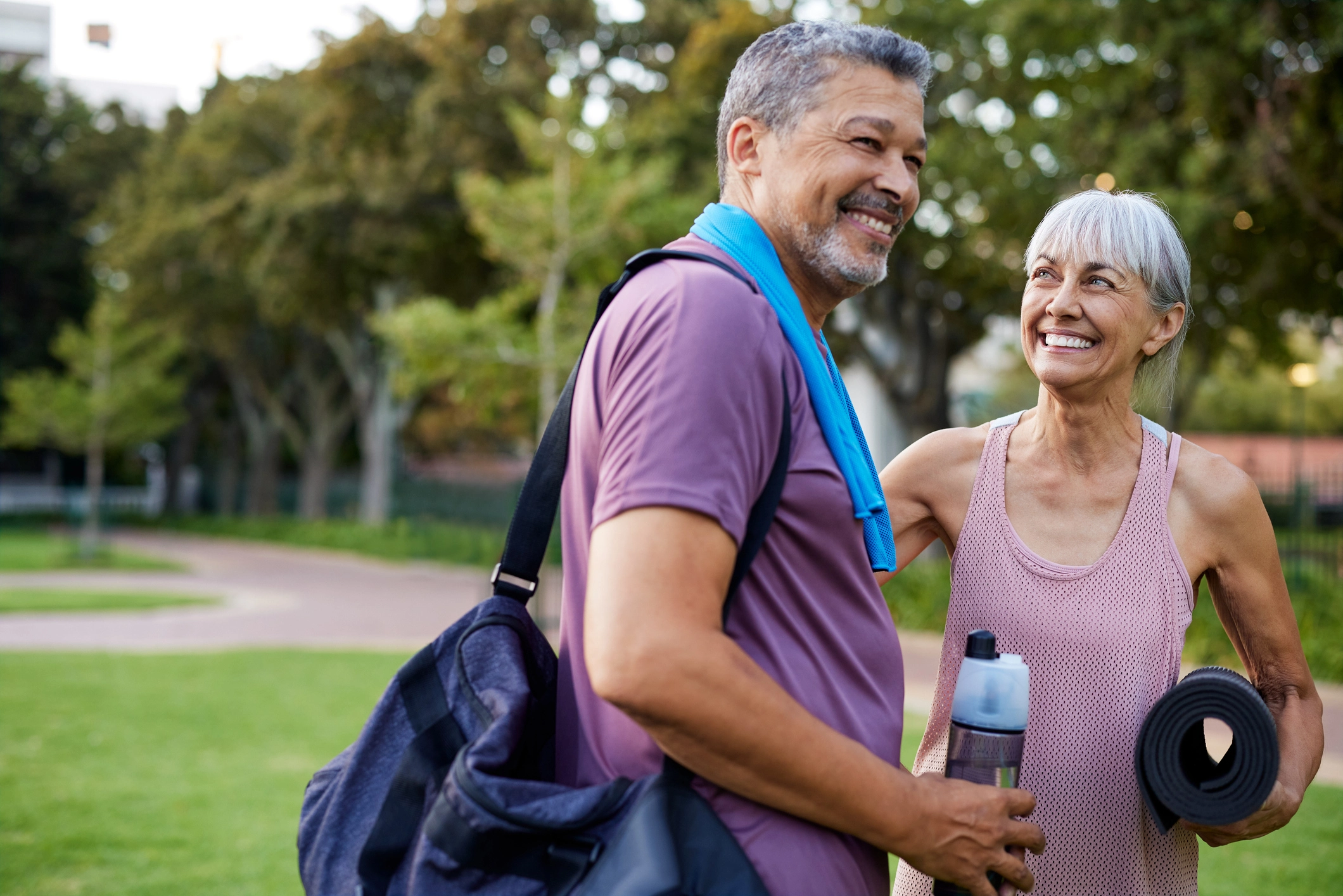 2 seniors smiling after exercising to better cholesterol and aging.