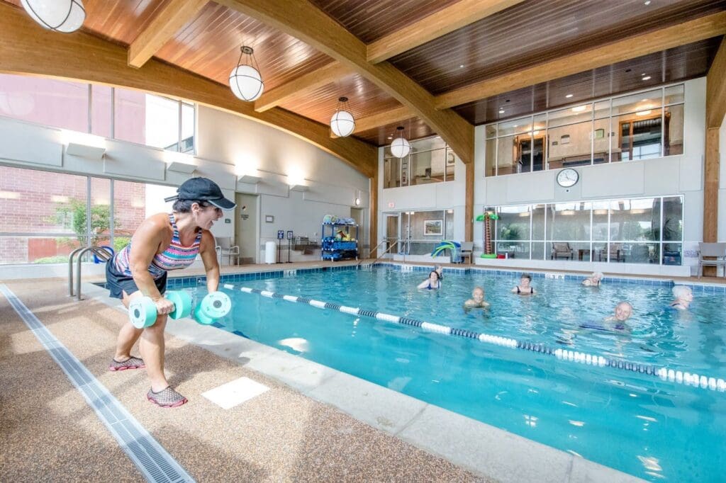 Instructor Leading Water Aerobics Class at Senior Living Community