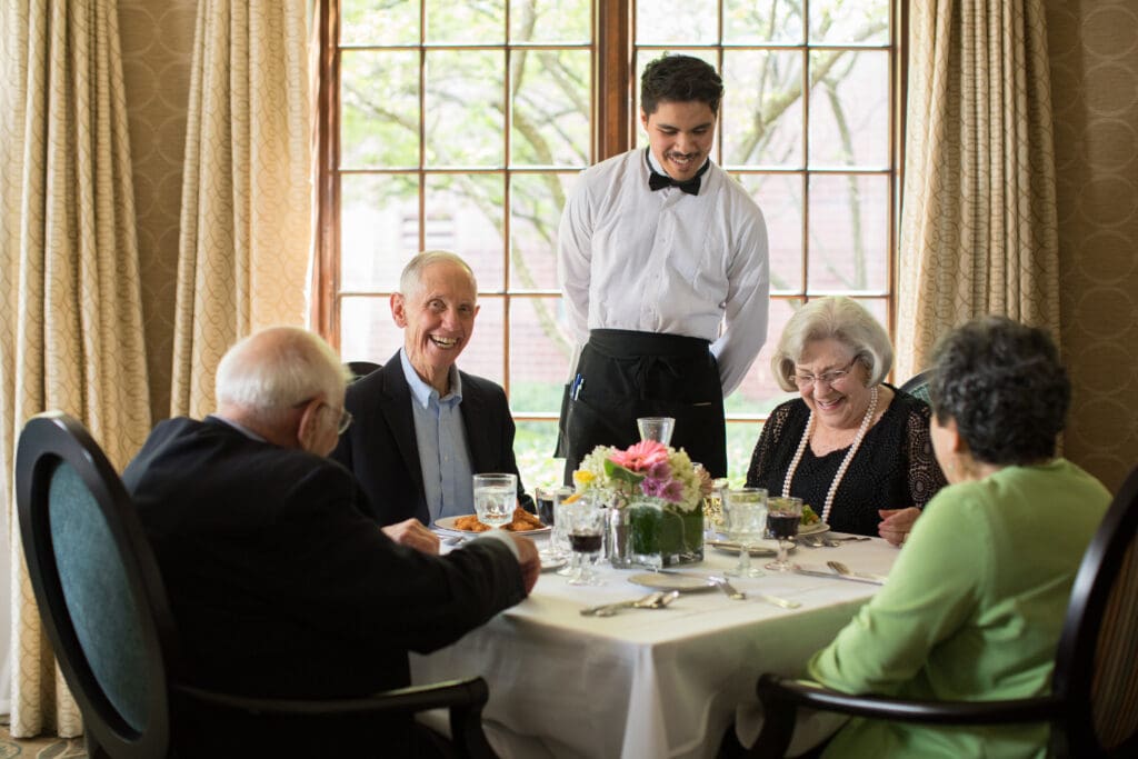 Waiter checking in on Wyndemere residents dining